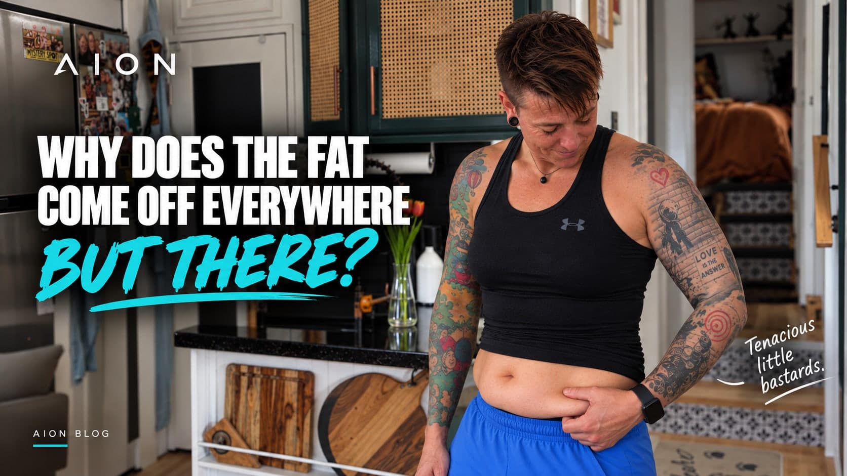 A tattooed woman in a black tank top stands in her kitchen, looking down and pinching the skin at her waist, beside the headline Why Does the Fat Come Off Everywhere BUT There? and the note: Tenacious little bastards.